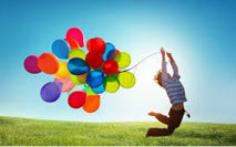 person jumping with colorful balloons